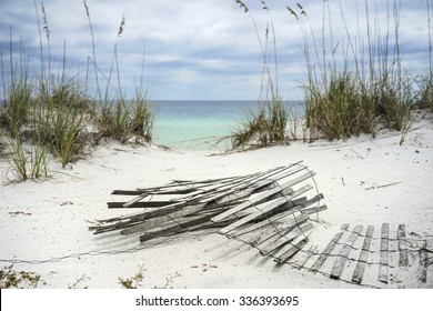Old sand fence lying on the beach in winter in Florida.