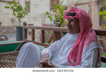 An Old Saudi Man Sits On A Balcony In The Old City Of Jeddah, Saudi Arabia 2020