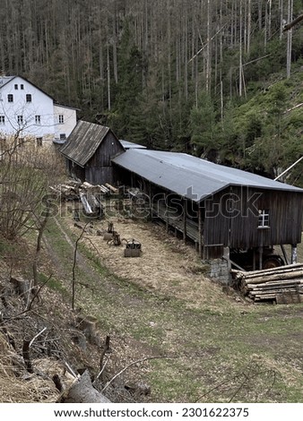 old sawmill building in the middle of the field