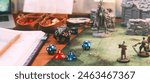 Old school game style with role playing and board games hobby concept. Dice 20 on table create fantasy story from imagination. Foreground with blur miniatures.