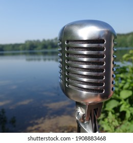 Old School Microphone In Front Of A Lake