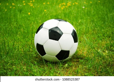 Old School Soccerball On Green Grass In Spring