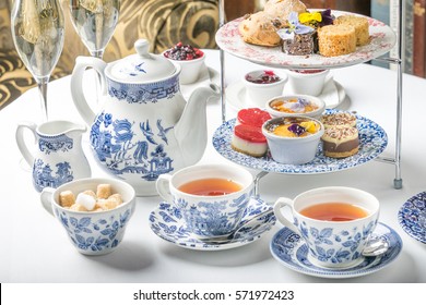old school style tea at five afternoon service sandwich set cake sweet traditional table hotel cheesecake sugar pot blue china cup 