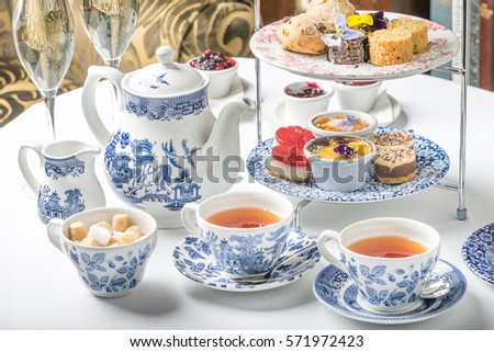 old school style tea at five afternoon service sandwich set cake sweet traditional table hotel cheesecake sugar pot blue china cup 