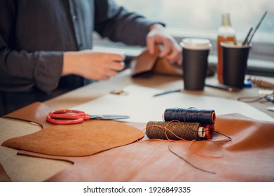 Old school workshop of an exclusive shoemaker. Spools of thread on the workbench. Cobbler at work. - Powered by Shutterstock