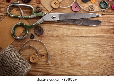 Old scissors and buttons on the wooden table - Powered by Shutterstock