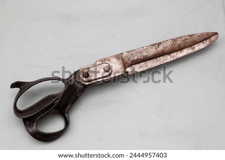 Old scissors on a wooden background. Vintage style. Top view.