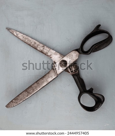 Old scissors on a wooden background. Vintage style. Top view.