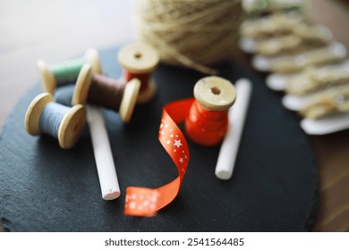 Old scissors, spools of colored thread, centimeter and tailors chalk, flat lay, concept of sewing