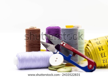 Old scissors, various threads and sewing tools on white background, selective focus, copy space.