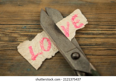 Old scissors with word love. Concept of divorce. Top view