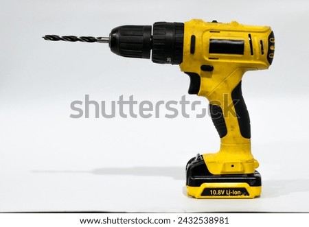 Old screwdriver with drill bit on white background.