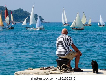 Old Seaman With Black Dog Enjoying Sailing Of Historical Regatta                      