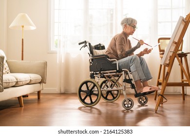 Old Senior Asian Female Tattoo Using Art Therapy While His Legs Is Injured At Home,asian Elder Woman Spend Recovering Of Her Leg Is Getting Better With Painting Canvas Art In Living Room At Home