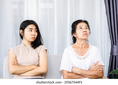 Old Senior Asian Mother Angry And Ignoring Her Young Daughter, Daughter Tired With Annoyed Mom Quarrel In Family Concept  