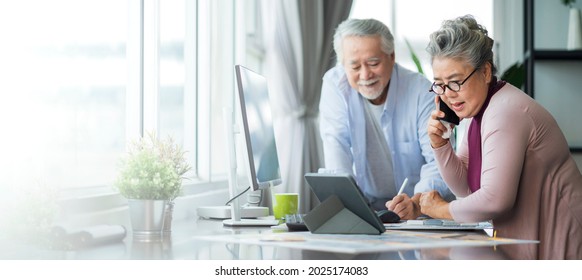 old senior asian retired people entrepreneur working together at home,home isolation remote jobs work with desktop and smartphone technology device work from home