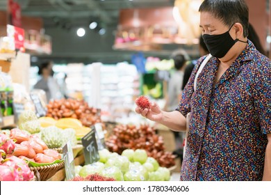 Old Senior Asian Woman Wear Virus Spread Protection Mask While Shopping Fresh Vagetable And Fruit At Grocery Store In Supermarket New Normal Lifestyle After Lockdown Is Over