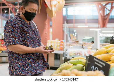 Old Senior Asian Woman Wear Virus Spread Protection Mask While Shopping Fresh Vagetable And Fruit At Grocery Store In Supermarket New Normal Lifestyle After Lockdown Is Over