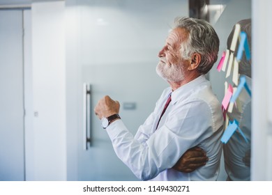 Old Senior Business Man Happy Working In Office, Reading Sticky Note Post It In Room