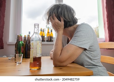 Old Senior Female Woman Sit Next To Table Drink Alcohol Bottle At Home Sad Alone Alcoholism Signs And Symptoms Rehab Abuse And Recovery Problems