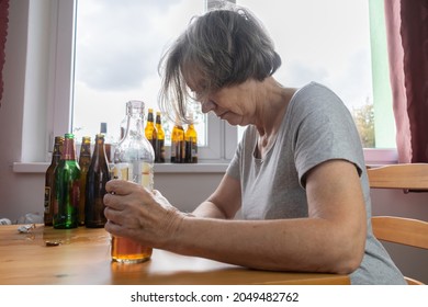 Old Senior Female Woman Sit Next To Table Drink Alcohol Bottle At Home Sad Alone Alcoholism Signs And Symptoms Rehab Abuse And Recovery Problems