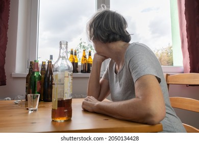 Old Senior Female Woman Sit Next To Table Drink Alcohol Bottle At Home Sad Alone Alcoholism Signs And Symptoms Rehab Abuse And Recovery Problems