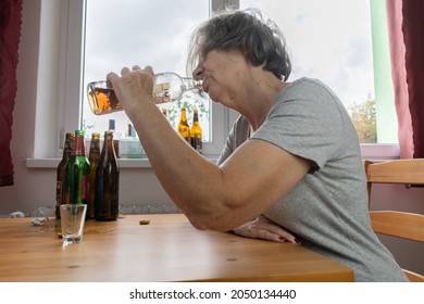 Old Senior Female Woman Sit Next To Table Drink Alcohol Bottle At Home Sad Alone Alcoholism Signs And Symptoms Rehab Abuse And Recovery Problems