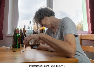 Old Senior Female Woman Sit Next To Table Drink Alcohol Bottle At Home Sad Alone Alcoholism Signs And Symptoms Rehab Abuse And Recovery Problems