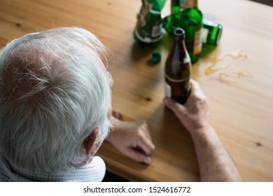 Old Senior Male Man Sit Next To Table Drink Alcohol Bottle At Home Sad Alone Alcoholism Signs And Symptoms Rehab Abuse And Recovery Problems