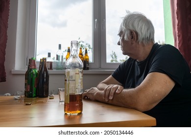 Old Senior Male Man Sit Next To Table Drink Alcohol Bottle At Home Sad Alone Alcoholism Signs And Symptoms Rehab Abuse And Recovery Problems