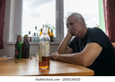 Old Senior Male Man Sit Next To Table Drink Alcohol Bottle At Home Sad Alone Alcoholism Signs And Symptoms Rehab Abuse And Recovery Problems