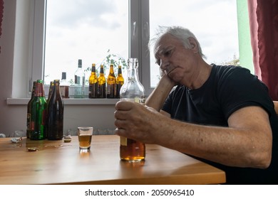 Old Senior Male Man Sit Next To Table Drink Alcohol Bottle At Home Sad Alone Alcoholism Signs And Symptoms Rehab Abuse And Recovery Problems