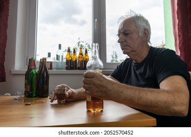 Old Senior Male Man Sit Next To Table Drink Alcohol Bottle At Home Sad Alone Alcoholism Signs And Symptoms Rehab Abuse And Recovery Problems