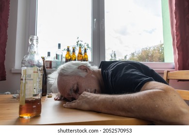 Old Senior Male Man Sit Next To Table Drink Alcohol Bottle At Home Sad Alone Alcoholism Signs And Symptoms Rehab Abuse And Recovery Problems