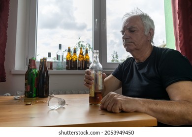 Old Senior Male Man Sit Next To Table Drink Alcohol Bottle At Home Sad Alone Alcoholism Signs And Symptoms Rehab Abuse And Recovery Problems