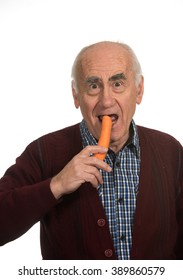 Old Senior Man Eating Carrot