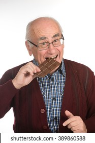 Old Senior Man Eating Chocolate