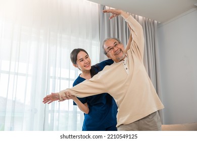 Old senior man enjoys training with physiotherapist for outstretched arms at home, Asian physical therapist patient nursing helping elderly exercising arm stretch, Rehabilitation of disabled concept - Powered by Shutterstock