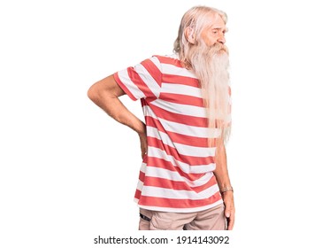 Old Senior Man With Grey Hair And Long Beard Wearing Striped Tshirt Suffering Of Backache, Touching Back With Hand, Muscular Pain 