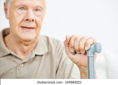 Old senior man with his hand on a cane - Powered by Shutterstock