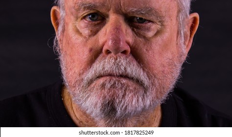 Old Senior Man With Scraggly Beard Looking At Camera