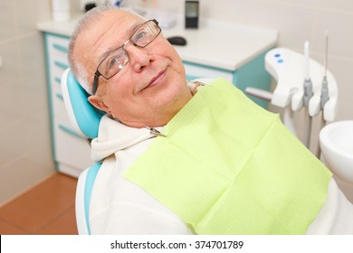 Old Senior Man Sitting In The Dental Office