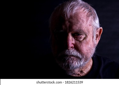 Old Senior Man With Unkempt Beard Looking Into Camera