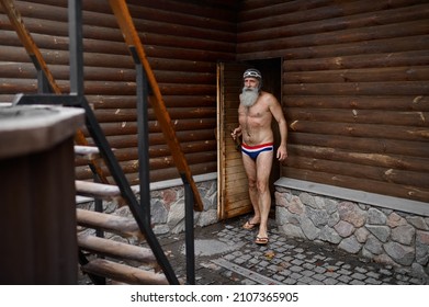 An Old Senior Man At Wooden Outside Sauna Bathtub