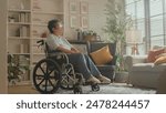 old senior retired woman in wheelchair Thoughtful asian senior woman sitting on wheelchair at home. Elderly female is looking through window elder woman in wheelchair alone at home