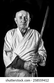 Old Sensei In A Kimono With Samurai Sword