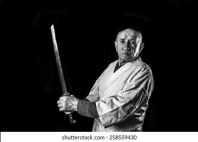 Old Sensei In A Kimono With Samurai Sword