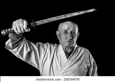 Old Sensei In A Kimono With Samurai Sword