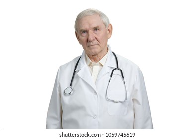 Old Serious Gloomy Doctor Portrait. Senior Physician With Stethoscope In White Isolated Background.