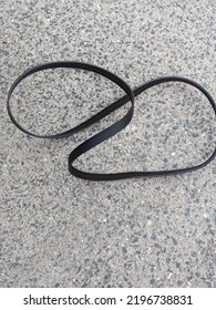 Old Serpentine Belt On A Shop Floor